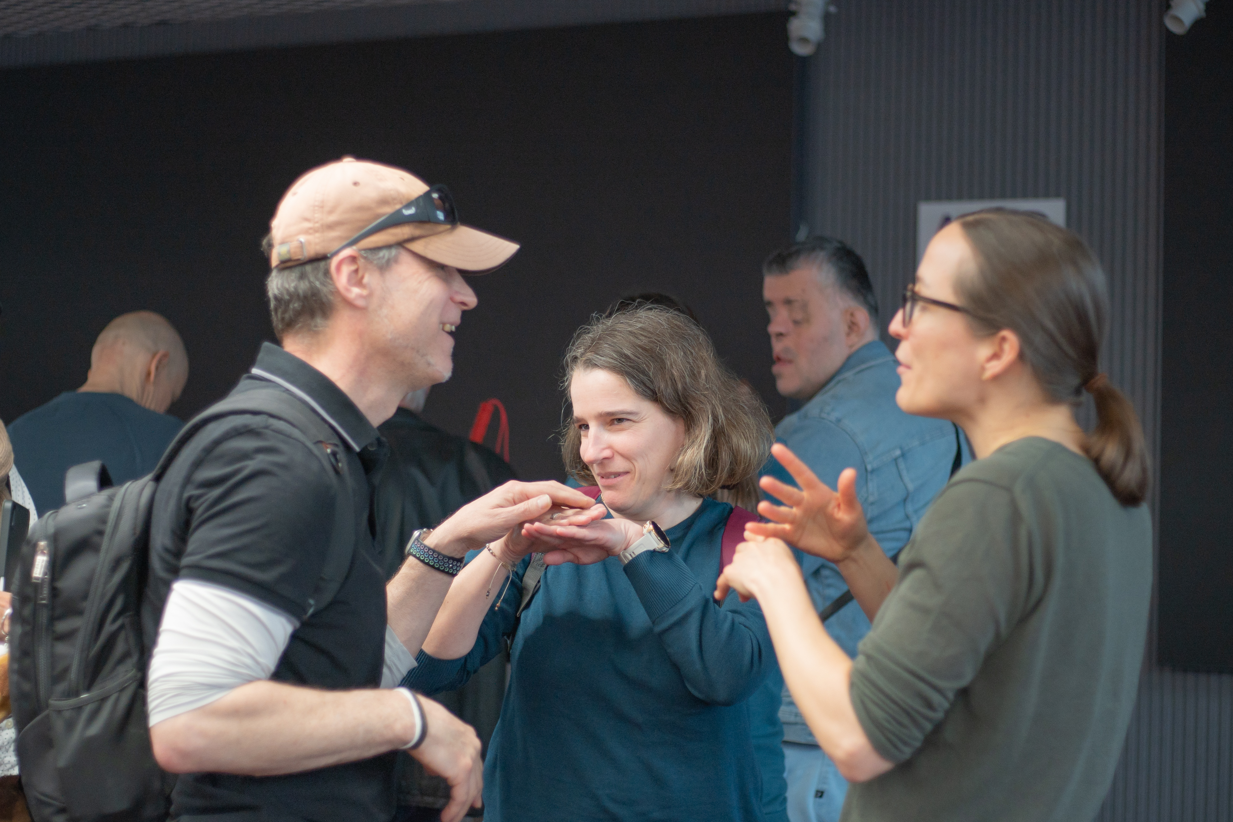 Conversation interpreted between spoken language and tactile signing 